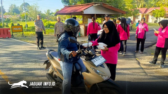 Ketua Bhayangkari Ranting Pinogaluman, Ny. Pratiwi Nani, bersama jajaran personel Polsek Pinogaluman menyapa pengguna jalan saat pembagian takjil gratis. Aksi sosial ini menyasar ratusan pengendara roda dua dan roda empat di depan Mapolsek Pinogaluman. Foto : Polsek Pinagoluman