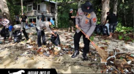 Personel Ditpolairud Polda Sulut dan jurnalis saat mengumpulkan sampah plastik dalam aksi bersih pantai Lembeh di Pantai Serena, Jumat (24/4/2026).