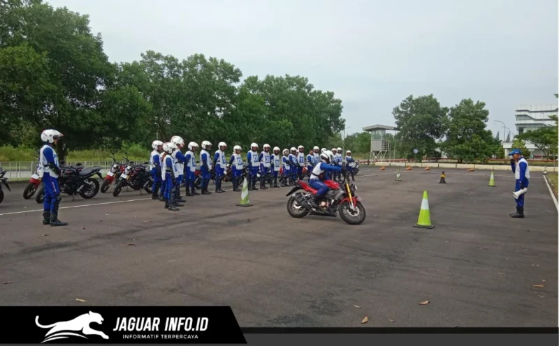 Seorang instruktur safety riding memberikan arahan teknis kepada peserta mengenai teknik engine brake motor yang aman dalam sesi pelatihan praktik