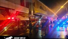 Petugas pemadam kebakaran saat berupaya memadamkan kobaran api di area luar gedung pusat perbelanjaan.